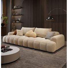 a living room filled with furniture and a round table in front of a wall mounted shelf