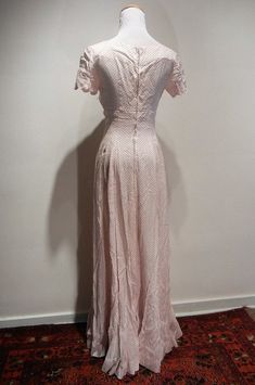 "The quintessential 1930 tea dress. Scalloped bust line and sleeves, fitted bodice, zip back, gorgeous framing of decollette, and a six gore bias cut flare to the skirt. Minor discoloration at edge of neckline in back. And how about those matching gloves that finish the look?! My mannequin has a 36 bust and 24\" waist. Length is 56\" from center neckline / collar to hem. It is fitting my mannequin as though it were made for her. The rib cage tapers to 26 under bust and to the waist to create the Party Dress Red, Vintage Tea Dress, Lawn Party, Paisley Fabric, Garden Lawn, Red Polka Dot, Tunic Shirt, Rib Cage, Red Dots