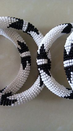 Bracelets | Custom Bracelets | Mother's Gift | Gift Idea | Bangles | Unique Gift | Bracelets For Women | Yoga Bracelets | Daughters Gift These superbly crafted Zulu beaded bracelets are made of fine beads which can be worn in any occasion. Color - White and black. Feel free to send me a convo or e-mail for any clarification. Thank you for visiting... Handmade White Bangle Bracelet, White Beaded Bracelets With Jubilee Style, Adjustable Beaded White Bangle, Adjustable White Beaded Bangle, Handmade White Bangle Friendship Bracelets, White Beaded Bangle With Round Beads, White Bohemian Bangle Wristband, White Beaded Bangle Jewelry, White Beaded Round Bracelets