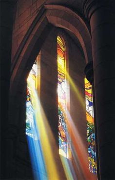 sunlight shining through stained glass windows in a church