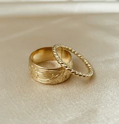 One of our most-loved rings ~ Marigold is a cigar band ring with a vintage floral design. Add this charming piece to your collection to stack or make a statement. * Customers report that this ring fits tight. Recommended to order 1/2 size up from your normal ring size if you prefer a more loose fit or if your fingers tend to swell. ﻿Band width: 8 mm // Band thickness: 0.5 mm Modeled with our bold rope ring Handmade to order in high-quality 14k gold fill to withstand daily wear time after time. Vintage Gold Band, Thick Band Engagement Ring, Custom Gold Rings, Rope Ring, Vintage Gold Rings, Time After Time, Vintage Floral Design, Jewelry Tattoo, Jewelry Lookbook