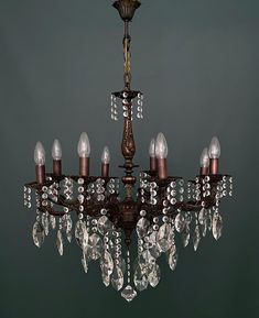 an antique chandelier with crystal drops hanging from it's center and bottom