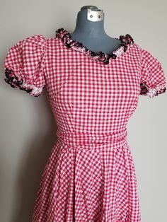 "Super adorable 1950's western style dress. This would be perfect for a dancing date! Or Valentines day! The dress has a fitted bodice with a side metal zipper and an 8 paneled circle skirt with some gathers. The dress also comes with a sash that can be tied around the waist or used as a hair decoration. Sleeves are puffed and there is black ric-rac trim adorning all the ruffles. Condition: Great vintage condition. General, minor signs of wear. I found two very small slight spots of discoloratio Dancing Date, Square Dance Dress, Western Style Dresses, Square Dance Dresses, Dress And Jacket Set, Square Dance, Henderson Nv, Square Dancing, Antique Clothing