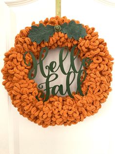 an orange wreath with the word fall painted on it