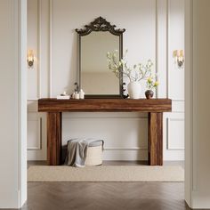 a wooden table with a mirror and vases on it in front of a white wall