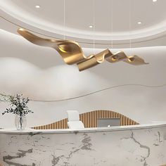 an elegant reception area with marble counter tops and gold leaf pendants hanging from the ceiling