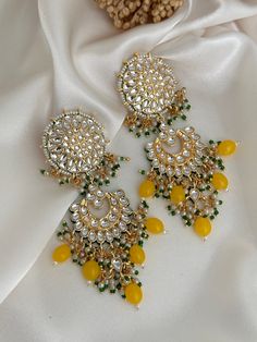 kundan  work pakistani style statement earrings, available in 3 colors.  Lightweight  Dimensions- Earrings length- see photos  Style tip- Pair it with any beautiful traditional outfits  and flaunt with Unique style of collection from us. Perfect match for Festival and Traditional wear.  Take Care Tips-  Kee away from perfume, Hair spray and. Moisture.  Store in dry place , Ziplock bag or Airtight box.    Clean with dry cloth.  Jewellery is the last thing you should wear and first thing you shoul Luxury Mirror Work Jewelry For Festivals, Luxury Diwali Jewelry With Mirror Work, Festive Kundan Chandelier Earrings With Mirror Work, Festival Kundan Bridal Earrings With Mirror Work, Kundan Bridal Earrings With Mirror Work For Festivals, Bridal Kundan Earrings With Mirror Work For Festivals, Kundan Danglers With Mirror Work, Festive Kundan Danglers With Mirror Work, Festival Chandbali Chandelier Earrings With Mirror Work