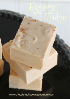 two pieces of soap sitting on top of each other with the words eggnog and fudge above them