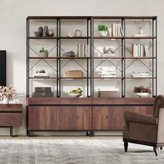 a living room filled with furniture and a large book case on top of a wooden shelf