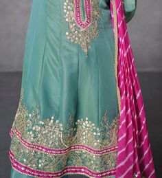 COLOR : Sea Green & Pink FABRIC : Top & Bottom - Organza Silk, Dupatta - Chinon Silk WORK : Silk Thread Embroidery, Gota Patti Work, Pearls, Foil Mirrors, Lace Border OCCASION : Wedding, Reception, Mehendi, Party Wear, Festival READY-TO-WEAR : No STITCHING : Available as semi-stitched fabric, can be stitched using standard size option (+$30). Note: There might be a slight color variation due to lighting and flash used during photoshoot. The bright shade seen is the best closer view of fabric's c Pink Raw Silk Palazzo Set With Gota Work, Pista Green Raw Silk Palazzo Set With Gota Work, Pista Green Dola Silk Fabric With Zari Embroidery, Pink Semi-stitched Dola Silk Unstitched Suit, Semi-stitched Green Embroidered Dola Silk Fabric, Pink Anarkali, Silk Anarkali, Lace Border, Sea Green