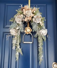 a blue front door with a wreath on the handle and flowers hanging from it's side