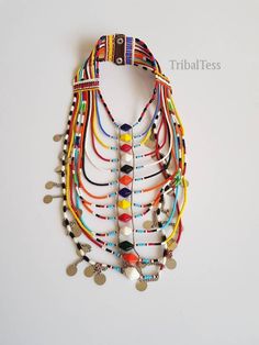 This necklace is 100% handcrafted using colorful fine beads. Perfect for weddings, traditional events, African themed events ect. The necklace has 13 strands all joined together. It has a leather closure with 2 buttons. Buy multiple items and pay shipping for ONE item only. **This necklace ships via DHL Express.(They take 3 to 5 days). More neckleces here; https://www.etsy.com/shop/TribalTess?ref=seller-platform-mcnav&section_id=21306083 Back to my shop; https://www.etsy.com/shop/TribalTess? Bohemian Bridal Necklace With Colorful Beads, Traditional Multicolor Beaded Necklaces For Ceremonies, Multicolor Necklace For Traditional Festivals, Multicolor Necklaces For Traditional Ceremonies And Festivals, Multicolor Necklaces For Festivals And Traditional Ceremonies, White Beaded Choker For Festivals, Handmade Multicolor Bridal Necklace With Round Beads, Multicolor Polished Round Beads Bridal Necklace, Multicolor Bridal Necklace With Polished Round Beads