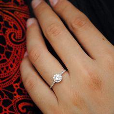 a woman's hand with a diamond ring on it