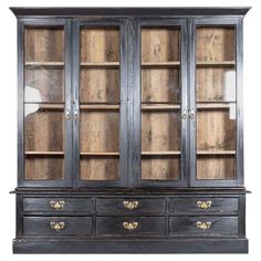 an old black china cabinet with glass doors