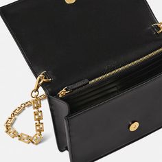 Elevate your evening look with the Greca Goddess Mini Bag. Adorned with the iconic Greca chain hardware, this Italian-crafted bag exudes luxury. The smooth leather and versatile design allow you to wear it as a shoulder or crossbody bag, making it the perfect accessory for any occasion. Upgrade your style with this signature Versace piece. Luxury Crossbody Wallet For Everyday Use, Designer Rectangular Evening Bag With Chain Strap, Designer Evening Bag With Chain Strap, Evening Crossbody Shoulder Bag With Chain, Rectangular Flap Bag With Chain For Evening, Luxury Business Clutch Crossbody, Formal Shoulder Bag With Chain, Luxury Business Crossbody Clutch, Formal Chain Crossbody Bag