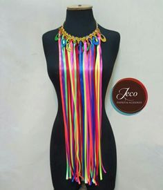 the mannequin is decorated with multicolored tassels and gold chains