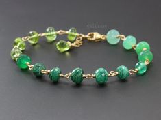 This Malachite 14K Solid Gold bracelet features breathtakingly gorgeous precious gemstones in an emerald green color palette. Here I have gathered gorgeous AAA quality rondelles faceted and smooth, larger and smaller, and wire wrapped each one separately with a wide Solid Gold 14K wire. As a combination they create an elegant, modern artisan bracelet. I [...] Emerald Green Color Palette, Pink Gemstone Bracelet, Green Gemstone Bracelet, Green Stone Bracelet, Pink Beaded Bracelets, Green Color Palette, Green Beaded Bracelets, Peridot Bracelet, Malachite Bracelet