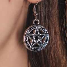 Unleash your inner gothic style with these stunning Pentagram Earrings! Made from high-quality alloy steel, measuring 2 inches in length, they feature a captivating black stone at the center of the pentagram. Add a touch of dark elegance to your wardrobe now! Gothic Nickel-free Jewelry For Festivals, Black Alloy Halloween Jewelry, Black Alloy Jewelry For Halloween, Gothic Antique Silver Nickel-free Jewelry, Gothic Round Metal Jewelry, Nickel-free Antique Silver Gothic Jewelry, Gothic Silver Alloy Jewelry, Mystical Nickel-free Black Jewelry, Mystical Black Nickel-free Jewelry