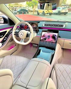 the interior of a mercedes s - class sedan with pink and white leather trims