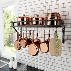 pots and pans are hanging on the wall