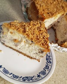 a piece of cake sitting on top of a blue and white plate next to a fork