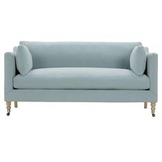 a light blue couch sitting on top of a white floor