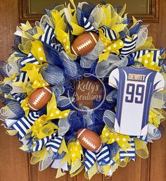 a wreath with footballs and ribbons on it