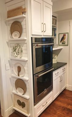 a kitchen with white cabinets and stainless steel appliances