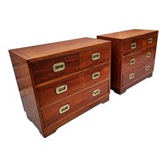 two wooden dressers with brass handles on each drawer and one has a white background