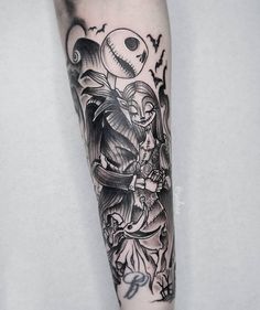 a man's arm with a black and white tattoo design on the left forearm