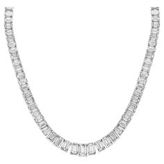 Elevate your elegance with our exquisite 19-inch Graduated Tennis Necklace, meticulously crafted in platinum and adorned with captivating emerald-cut diamonds. Each diamond is expertly set in a secure four-prong setting, showcasing their brilliance and clarity. The focal point of this masterpiece is the GIA certified H/SI2 emerald center, weighing 1.51 carats, radiating with unparalleled beauty and sophistication. With a total diamond weight of 30.04 carats, this necklace is a true statement of luxury and refinement. Indulge in timeless elegance with our Graduated Tennis Necklace, a symbol of enduring beauty and sophistication. Luxury White Gold Emerald Necklace With Brilliant Cut, Luxury White Gold Brilliant Cut Emerald Necklace, Luxury White Gold Emerald Necklace With Diamond Accents, Luxury Emerald Cut Diamond Necklace For Formal Occasions, Luxury Emerald Cut Diamond Necklace For Formal Events, Luxury Emerald Diamond Cut Necklace, Luxury Baguette Cut Emerald Necklace For Formal Occasions, Luxury Baguette-cut Emerald Necklace For Formal Occasions, Elegant Baguette Cut Emerald Necklace For Formal Occasions