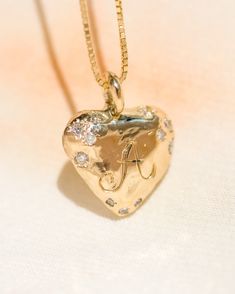 This sweet little 14k gold loveletter heart pendant is customizable with your very own initial or that of your beloved, with delicate little Diamonds kissing the edges. See attached photos for font example with your custom engraved initial. Set on a 16" or 18" delicate 14k chain in your choice of Box chain or Singapore chain. (see attached photo for examples) 💌 Please write desired length (16" or 18") in *Notes* section at checkout *Diamonds are stones of enlightenment, clarity of mind, imagination and inventiveness, fearlessness and the purity of love. Long valued for their magical properties and believed to have fallen from the sky after a battle between dragons, Hindus, over fifteen centuries ago, believed they provided their keepers with protection, courageousness, victory and the enh X Box, Box Chain, Guinea Bissau, Mozambique, Kenya, Heart Pendant, Coco, Initials, Chain