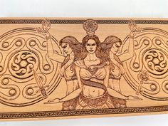 an intricately carved wooden plaque depicting three women