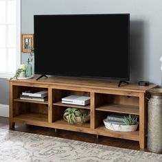 a flat screen tv sitting on top of a wooden entertainment center