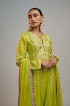 Editor's Note This anarkali, paired with a churidar and a beautiful chiffon badla dupatta, features flowing kalis down the waistline, adding a playful touch to the ensemble, perfect for any occasion. Designer Green Cotton Silk Anarkali Set, Green Anarkali Cotton Silk Palazzo Set, Green Palazzo Set With Dabka Work And Straight Kurta, Anarkali Style Floor-length Pista Green Palazzo Set, Pista Green Anarkali Kurta With Dupatta, Green Cotton Silk Lehenga For Eid, Green Palazzo Set With Sheer Dupatta In Traditional Drape, Green Cotton Silk Sharara For Festive Occasions, Anarkali Kurta In Pista Green With Dupatta