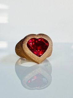 With its sentimental and sweet vibe this ruby signet ring is a modern take on the universal symbol of love. Perfect for everyday or special occasions it adds a fun element to any look. Ring face 17mm x 18mm Ruby 12mm x 11mm Set in 9K hand finished textured rose gold. Can be customized to polished and brushed finish. Weight  9.50-11 grams. Please contact us for sizing options. Follow us on Instagram: https://www.instagram.com/missionewyork/ Modern Heart Cut Rings For Gifts, Modern Heart-shaped Anniversary Rings, Modern Heart Shaped Anniversary Rings, Valentine's Day Heart Shaped Signet Ring, Valentine's Day Heart Shaped Fine Jewelry Signet Ring, Modern Heart-shaped Rings For Valentine's Day, Valentine's Day Heart Shaped Signet Ring In Fine Jewelry, Heart Shaped Signet Ring For Valentine's Day, Heart-shaped Signet Ring For Valentine's Day