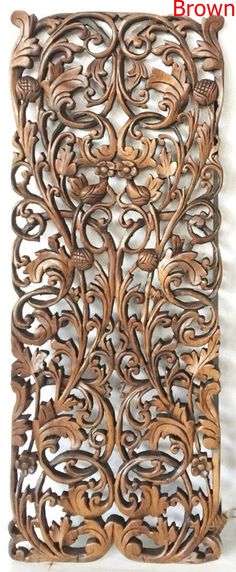 an intricate carved wooden panel with leaves and flowers on it's sides, in the shape