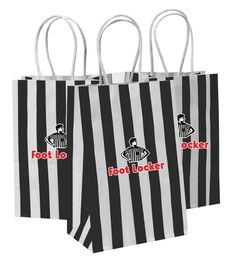 three black and white striped shopping bags with red foot locker logo