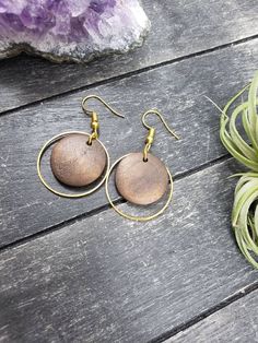 "These lightweight dangle earrings feature 18mm dark brown unfinished wooden discs dangling inside 25mm gold plated brass hoops. The ear wires are made of hypoallergenic gold plated surgical steel, making these earrings safe for sensitive ears! They are super lightweight, each weighing only 0.1 ounce. They measure approximately 1.75 inches from the top of the ear wires to the bottom of the gold hoop. Domestic shipping is always free here at Mayamadethis! When will my item ship? Every single item Brown Small Hoop Earrings With Ear Wire, Minimalist Brown Hoop Earrings For Gift, Brown Circular Earrings As Gift, Brown Circular Earrings For Gift, Brown Circular Earrings For Gifts, Hypoallergenic Brown Round Earrings, Brown Wooden Drop Earrings, Brown Wood Drop Earrings, Brown Round Earrings For Pierced Ears