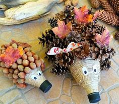 two animal made out of pine cones sitting on top of a stone floor next to other decorations