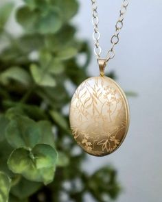 This gold filled locket is a beautiful, classic piece of jewelry now engraved with a delicate floral pattern. Select the light finish for a subtle engraving, reflecting in gold  or the darker fill to see the a bolder contrast accentuating the flowing lines along the locket surface. This will be a lasting heirloom that can be worn and treasured throughout the wonderful moments of your life.  ITEM DETAILS  * See listing photo for available Gold Filled locket sizes * Available in the classic polished or brushed matte style * Gold Filled chain * Engraving samples shown on: Top left to right: shiny light engraving, shiny dark engraving bottom left to right: matte light engraving, matte dark engraving  Additional engraving and photos can be purchased with this listing: http://etsy.me/1yX7s3S  HO Elegant 14k Gold Locket Necklace Gift, Gold Locket Necklace With Intricate Round Pendant, Gold Locket Necklace With Intricate Design, Gold Locket Necklace With Intricate Design And Round Pendant, Elegant Round Pendant Locket Necklace With Birth Flower, Elegant Round Locket Necklace With Birth Flower, Elegant Yellow Gold Locket Necklace For Keepsake, Elegant Birth Flower Round Pendant Locket Necklace, Wedding Pendant Jewelry With Engraving Option