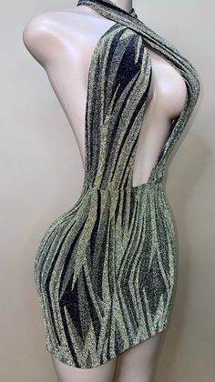 a mannequin wearing a green and black dress with zebra print on the back