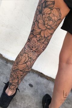 a woman's leg with flowers on it