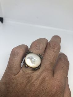 Vintage Mother of Pearl 925 Sterling Silver Marcasite Ring https://www.etsy.com/listing/633190735/vintage-mother-of-pearl-925-sterling?utm_source=crowdfire&utm_medium=api&utm_campaign=api Elegant Open Moonstone Ring Stamped 925, Victorian Style Pearl Ring Gift, Victorian Pearl Ring Gift, Victorian Pearl Ring Gemstone Gift, Vintage Pearl Ring With Gemstone, Victorian Pearl Ring With Gemstone For Gift, Elegant White Nickel-free Rings, Oval Sterling Silver Pearl Ring For Gift, Elegant Collectible Moonstone Ring