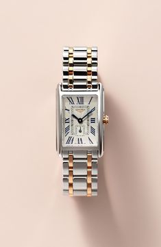 Launched in 1997, the DolceVita collection expresses a contemporary interpretation of watchmaking elegance. The slim rectangular case, a silver flinqué dial, blue steel hands and painted Roman numerals create a refined, feminine aesthetic. Style Name:Longines Dolcevita Bracelet Watch, 20.5mm X 32mm. Style Number: 5462325. Available in stores. Roman Numeral Wrist Watch, Elegant Silver Watch With Square Face, Elegant Rectangular Watch Accessories With Date Display, White Gold Watch Accessories With Rectangular Metal Dial, Elegant Watches Women, Rectangle Watch, Gold And Silver Watch, Womens Designer Watches, Vintage Watches Women