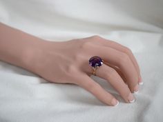 This setting is a true classic! Considered the height of fashion in the Mid Century era, the lines of this simple solitaire are clean and well balanced, providing a sophisticated look! We've set this vintage setting with a gorgeous amethyst. A deep regal purple hue, this sparkling stone glitters with intense fire from every facet.Metal: 18K Yellow GoldGem: Amethyst 10.11 CaratsGem Measurements: 17.1 x 14.9 mm, OvalRing Size: 7.50Marks: “18K” Stamped on the inside band Luxury Solitaire Amethyst Ring, Elegant Amethyst Wedding Ring, Elegant Wedding Amethyst Ring, Elegant Green Amethyst Ring, Timeless Formal Amethyst Ring, Classic Purple Amethyst Round Cut Ring, Classic Purple Amethyst Ring Round Cut, Classic Purple Amethyst Ring With Round Cut, Formal Purple Amethyst Solitaire Ring