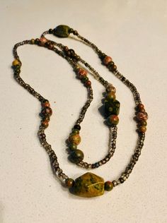 A natural stone beaded necklace which was hand beaded and is over 20 inches long. Beautiful natural colour stones with earthy tones. Rad Outfits, Bead Necklaces, Stone Beaded Necklace, Metal Tags, Long Beaded Necklace, Necklace Long, Jewellery Making, Earthy Tones, Boho Necklace