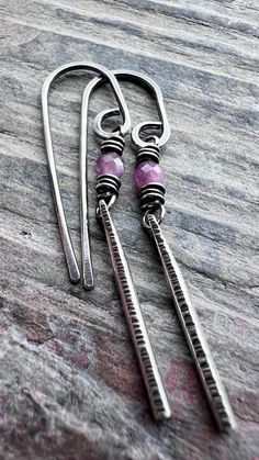 These customizable birthstone dangle earrings are handmade from sterling silver and genuine gemstones. The lightweight and dainty earrings feature two tiny birthstones wrapped in sterling silver. Below the natural gems dangle silver bars which I hammered to create the lined texture. The earrings can be personalized with the birthstone of your choice. The earrings dangle from handmade sterling silver earwires. Be sure to see all photos and video for size and color reference. Birthstone Size: Abou Earwires Handmade, Cold Connections, Color Reference, Birthstone Earrings, White Moonstone, Birthstone Earring, Silver Bars, Dainty Earrings, Gift Card Shop