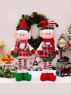 two red and white christmas decorations with green feet