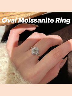 a woman's hand with a diamond ring on her finger and the words oval moissanite ring